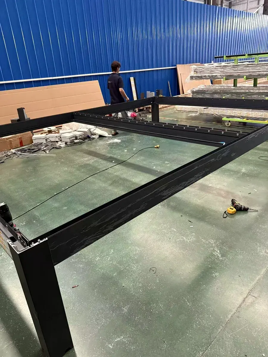 Aluminum pergola frame assembly on factory production floor